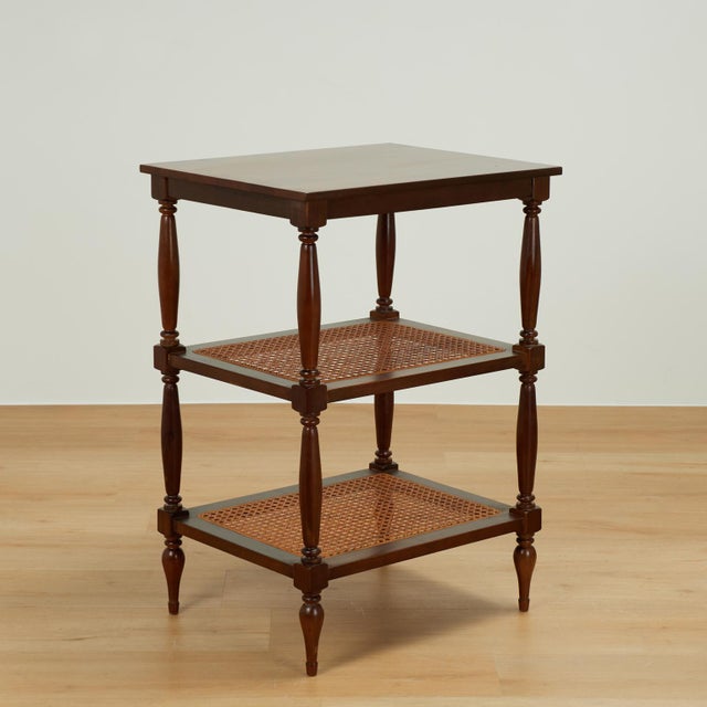 Handsome pair of vintage British colonial style stands crafted in mahogany with two caned lower tiers on classic turned...