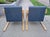 Newly reupholstered in a stunning blue nubby woven fabric with yellow undertones, this pair of birch bentwood Model 402...