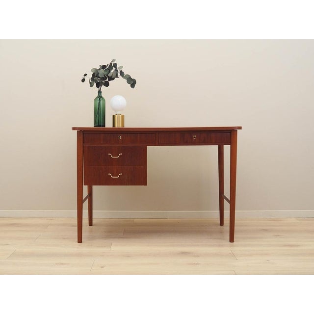 The desk was made in the 1960s in Denmark. The frame and tabletop are covered with teak veneer. The legs are made of solid...
