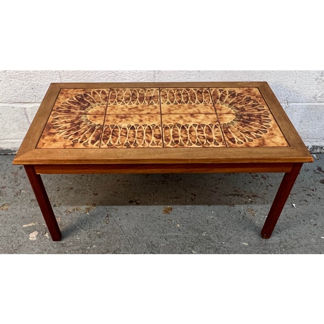 A striking 1960s Danish Mid-Century Modern tile top coffee table that perfectly blends Scandinavian craftsmanship with...