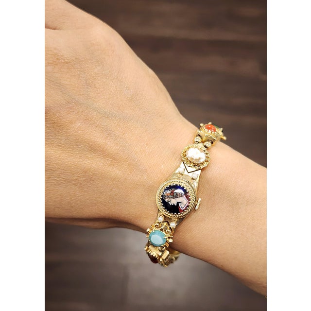 This ornate rainbow gemstone bracelet is a captivating expression of vintage sophistication and intricate design....