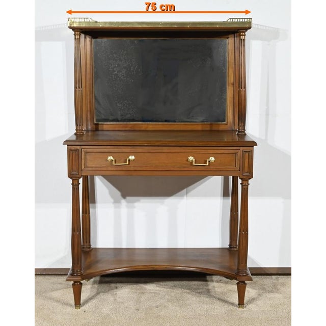 This cherry console table opens on a belt by a relaxation facade drawer with molded baguette and drooping ties. The feet...