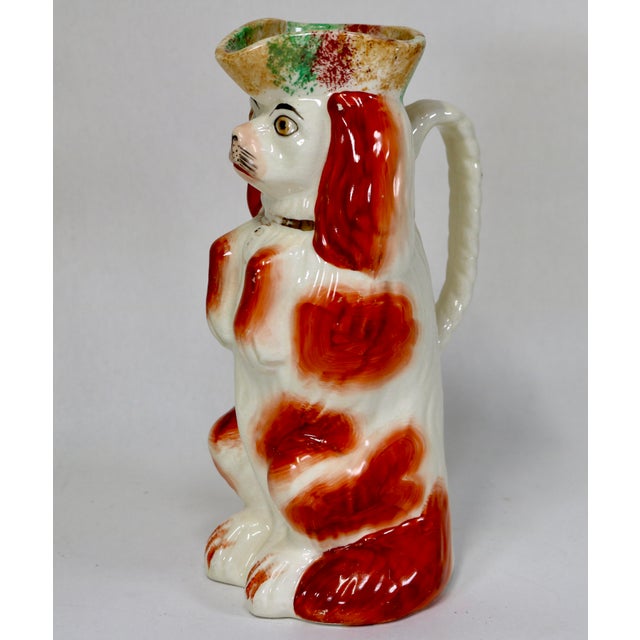 King Charles Spaniel Toby Jug having a hand painted orange and white colored coat, with a gold collar and padlock,...