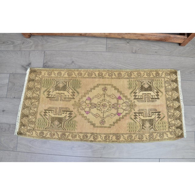 This is a vintage Turkish Oushak rug from the 1960s. The piece was hand-knotted.