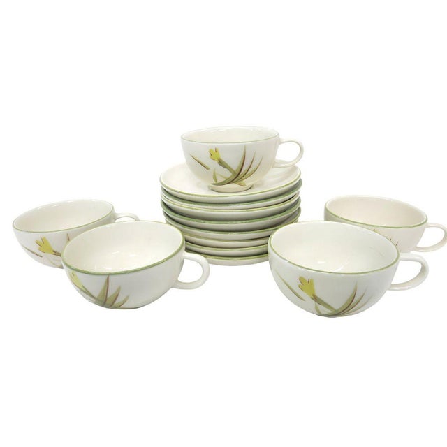 Capture the essence of mid-century California style with this exquisite 43-piece hand-painted china set by Winfield...