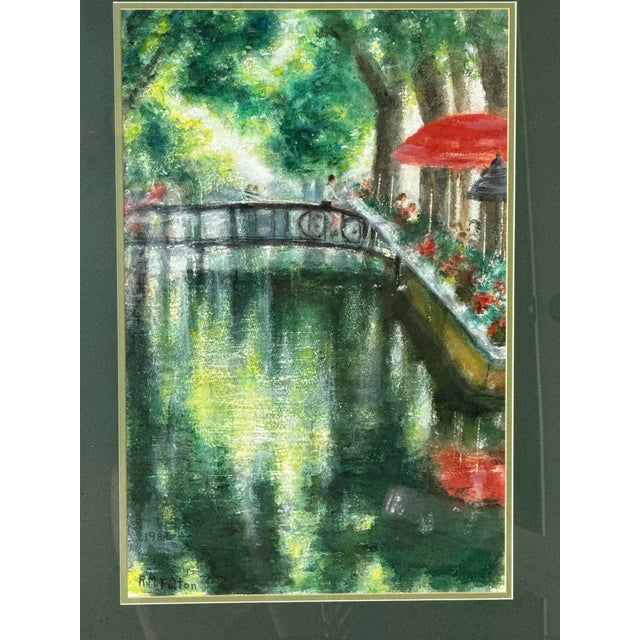 This charming impressionist watercolor by R.M. Fulton, dated 1986, features a peaceful European-style bridge stretching...