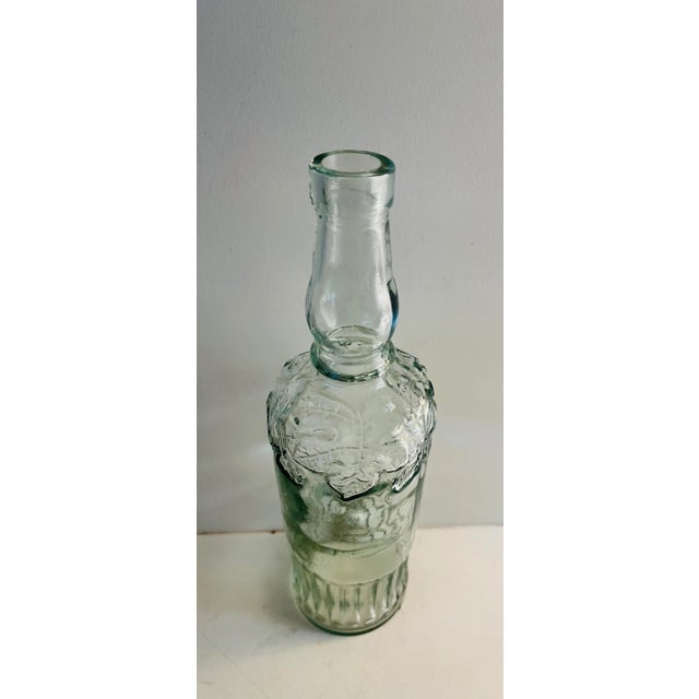 Beautiful vintage oak leaf motif glass bottle. Estate sale find.