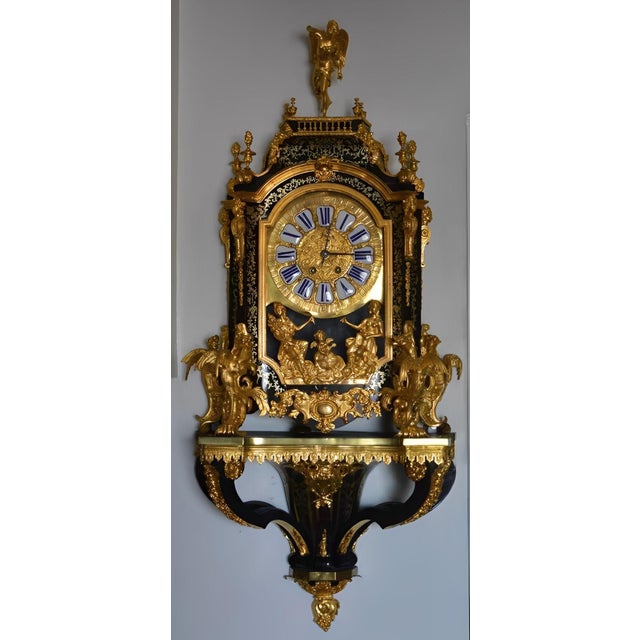 An exceptional and richly ornamented 19th century French Boulle cartel clock with matching pedestal, executed in the grand...