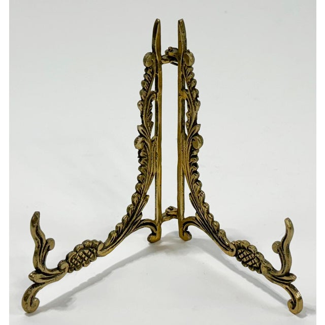 Vintage brass floral motif collapsible table easel with scroll and vine detail. Age wear. Patina.