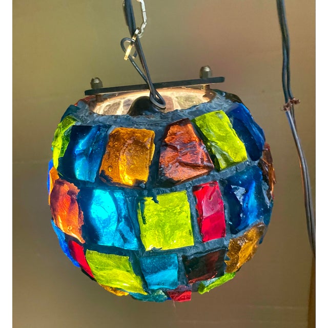 This is a fantastic brutalist style hanging globe made of large chunks of glass fragments in a multitude of colors...