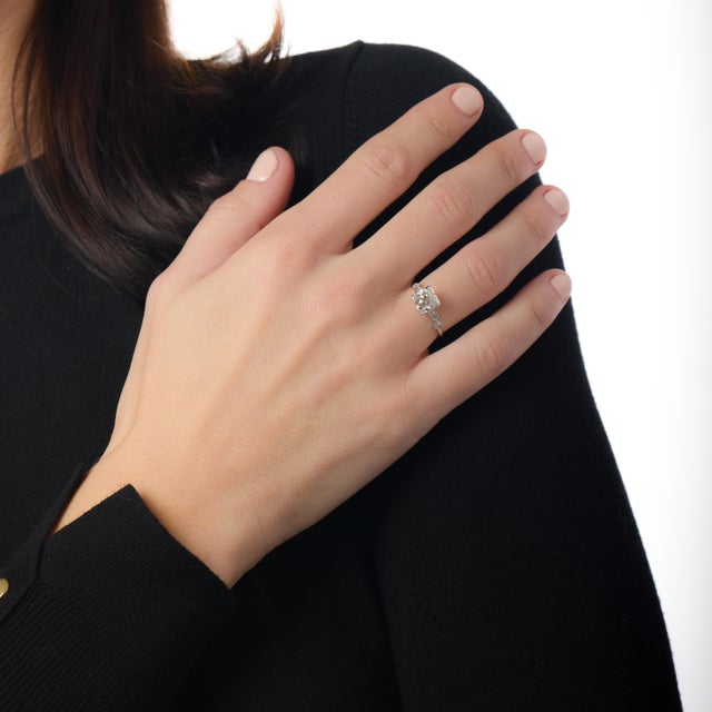 Certificate: GIA #2233758239 Center stone: Old European cut diamond Weight: 1.65 carats Color: O-P Clarity: VS2 Accent...