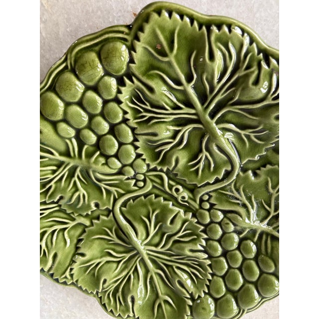 Majolica green ceramic platter shaped like grape leaves and fruits, made in Portugal.