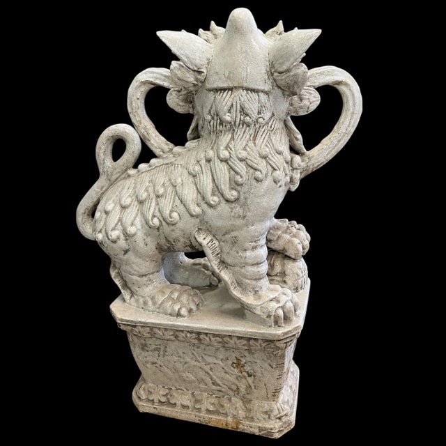 This is a set of large scale mid-century Chinese Export foo dog figurines. One has a paw on a reticulated ball, while the...