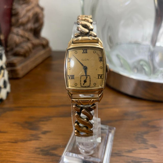 Beautiful vintage Elgin mechanical wristwatch featuring a 10K gold-filled case with an elegant rectangular Art Deco-...