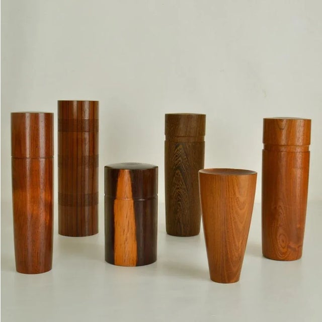 Set of six refined hand turned wooden boxes each in a different specimen in straight and tapered cylinder shape in various...