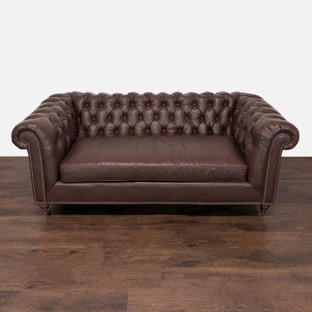 This Highland House 3-seat sofa features a classic Chesterfield design with deep button tufting and rolled arms....