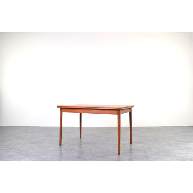 This teak extendable table was produced in Denmark in the 1960s. The furniture has been professionally and carefully...