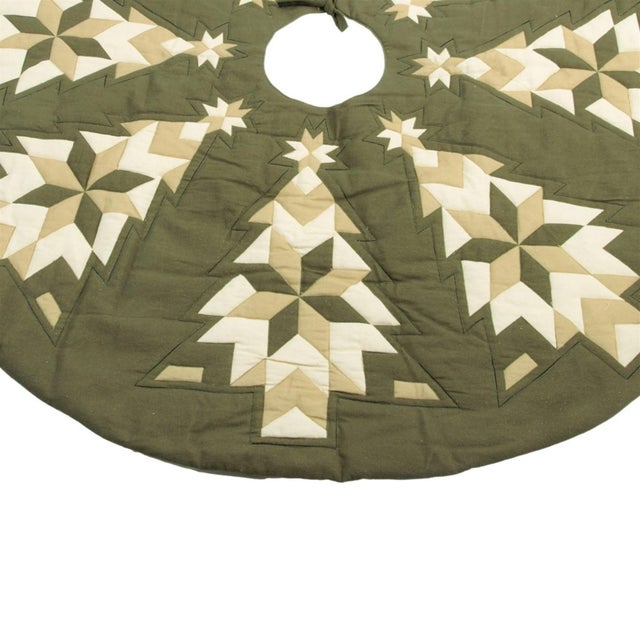 Create a warm, homespun holiday look with this beautifully crafted patchwork Christmas tree skirt. Featuring stylized tree...