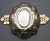 Silver, chased, engraved, and gilded. Harmonious oval shape with chased Dutch flowers, floral handles on the sides, and a...