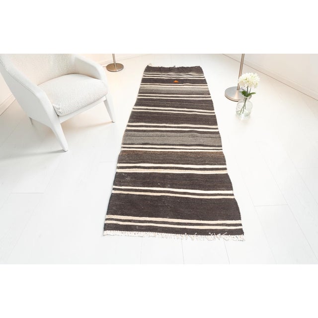 This is a vintage Turkish Oushak rug from the Mid 20th Century. The piece was hand-knotted.