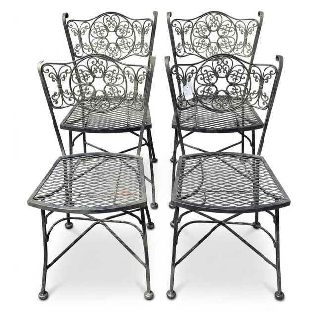 Set of four Wrought Iron chairs with matching table. Dimensions of chair: 20"x24"x40" Dimensions of table: 60"x32.5"x28.5"