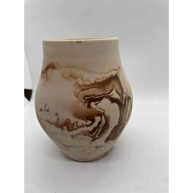 Embrace the rustic charm and artisanal beauty of the Nemadji Indian culture with this exquisite hand-painted swirl pottery...
