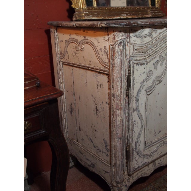 18th Century French provincial buffet painted in white and grays. Old patina. Molded top, two arched doors and inside shelf.