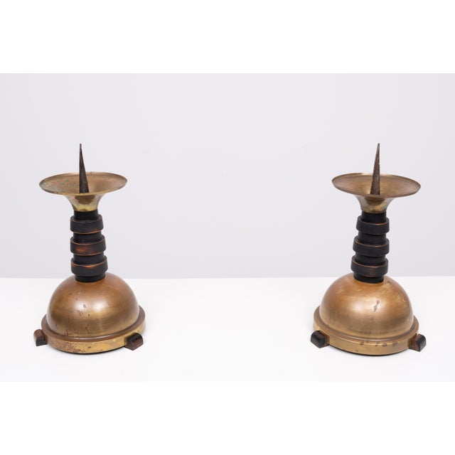 Very nice pair Church Candle sticks in a Amsterdam School style . Dutch Art Deco. 1920/30s Brass with wood feet . In the...