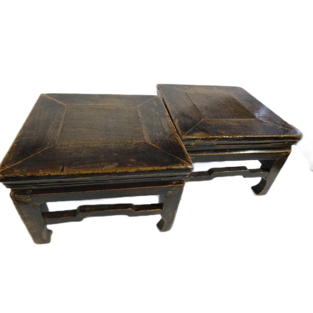 The pair of low square foot stools retain their original finish and the old patina is a good reflection of antique Chinese...