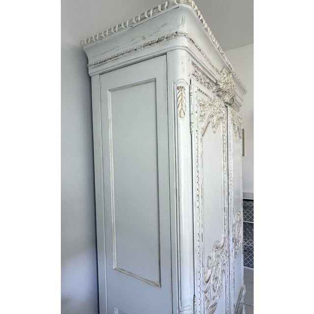 A true statement of craftsmanship and timeless grace. This magnificent Louis XV–style armoire commands attention with its...
