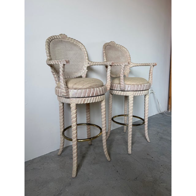 A beautifully crafted pair of vintage carved wood swivel bar stools featuring hand-carved rope twist detailing throughout...