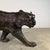A large-scale bronze tiger sculpture depicted in a slow, deliberate walking stance, this piece emphasizes mass, movement,...