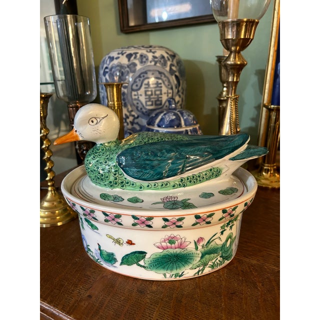 This oval shaped Chinoiserie tureen or covered dish is hand painted in vivid shades of green, teal and pink. The best...