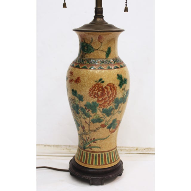 Late 19th century Japanese baluster form vase now mounted as a lamp. Carved wood base. Crackle glaze with enamel...