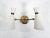 A single lassic of ivory white and gold 1950's wall sconce in the manner of Stilnovo Italy. The two light cones are...