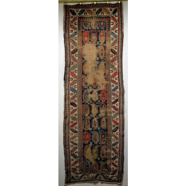 This antique Caucasian Kazak runner, woven in the fourth quarter of the 19th century, carries an allover paisley — or...