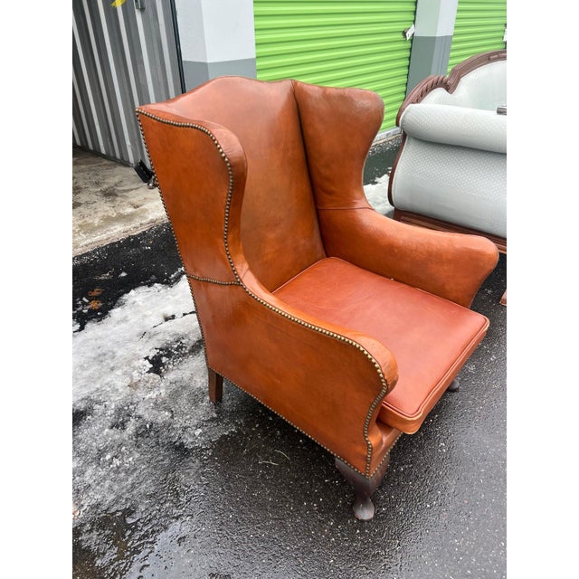 This classic leather wingback chair is upholstered in a rich saddle-colored leather with a warm, timeless patina. Designed...
