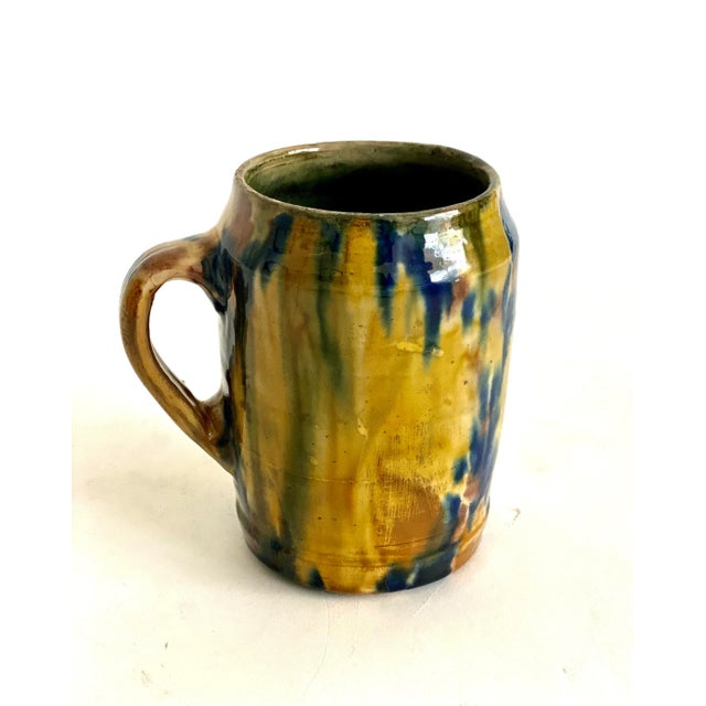 Beautiful French glazed majolica cup with handle. Vivid drip glaze colors and patina.
