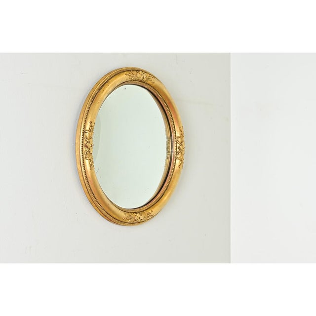 The restrained elegance of this 19th century English convex mirror is evident as graceful carvings and velvety texture in...