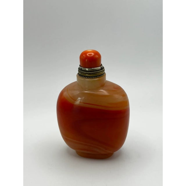 This is an interesting bottle - a glass bottle made specially to resemble banded agate. It is tall and square in shape...
