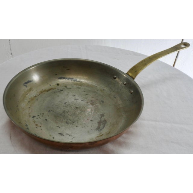 French copper frying pan. Hand-forged with a brass handle. Very heavy with a nice aged patina. Handle length: 7.5. Forged...
