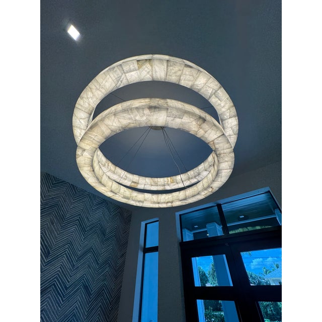 Minimalist in form, dramatic in effect, RH's Rivage chandelier by Timothy Oulton celebrates the beauty of calcite, a...