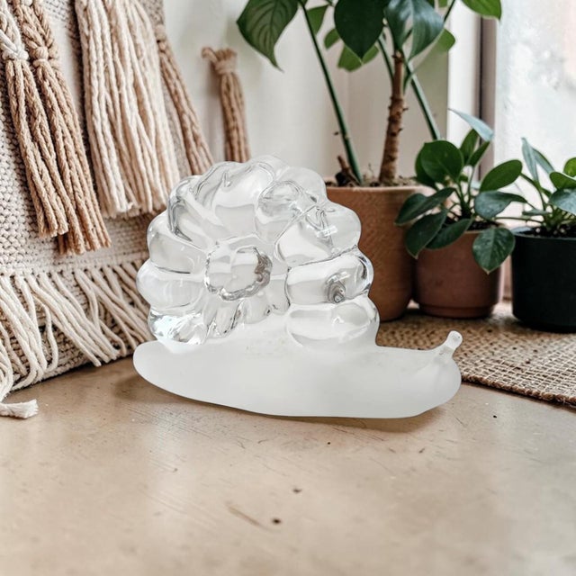 This elegant piece not only serves as a practical paperweight but also adds a touch of whimsy to any shelf or desk. Its...