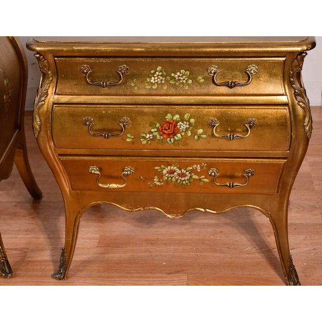 We are pleased to offer this beautiful pair of French Nightstands, from the 1940 . This pair is made of fruite wood gold...