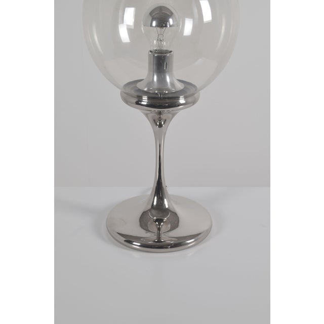 Space Age table lamp manufactured by Doria Leuchten in the 1970s. This lamp (50 cm high) has a chrome base with a glass...