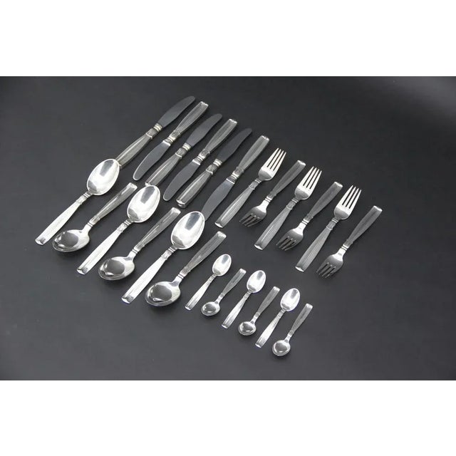 Lotus Cutlery in Silver 830, 1940s, Set of 24, in Very Good conditions. Designed 1920 to 1949 This piece has an...