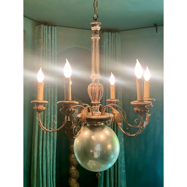 Elevate your interior with this captivating Hollywood Regency chandelier, a true statement piece that embodies vintage...