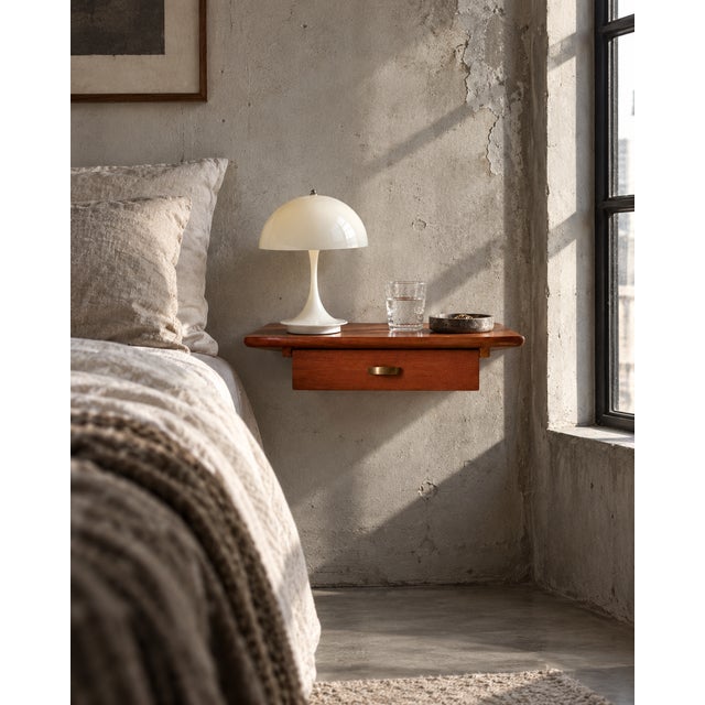 Petite danish wall-mounted bedside table in teak, c. 1960s. exceptionally compact design with a single drawer and open...