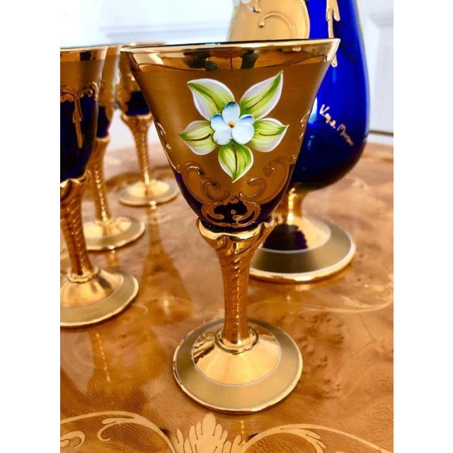 This exquisite liqueur set, featuring a decanter and five glasses, was handcrafted in Venice by renowned glass artists...