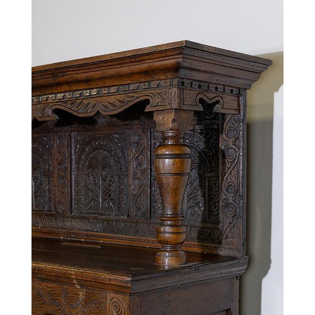 This impressive antique court cupboard or buffet à deux corps (two-part hutch) exemplifies the robust craftsmanship of...